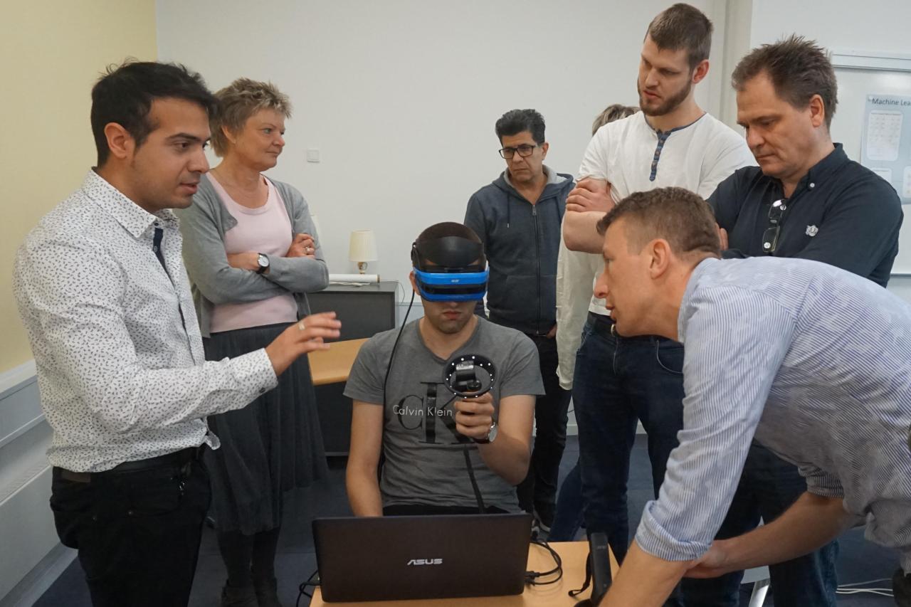 VR Emergency Room demo with team of professionals observing a user in a mixed reality headset