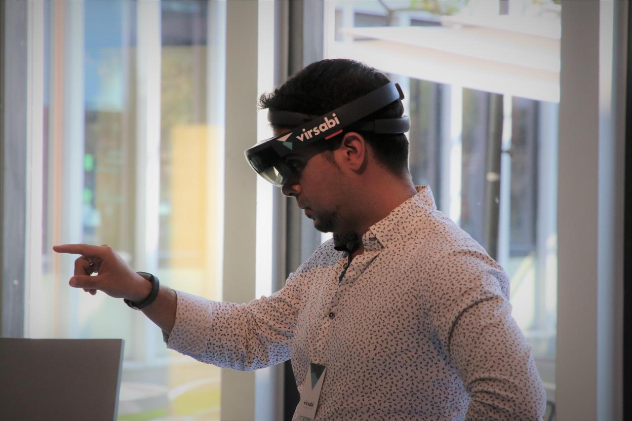 Developer wearing HoloLens demonstrating Mixed Reality knowledge transfer application