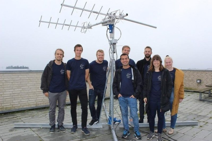 Delphini-1 satellite mission team with antenna assembly at Aarhus University